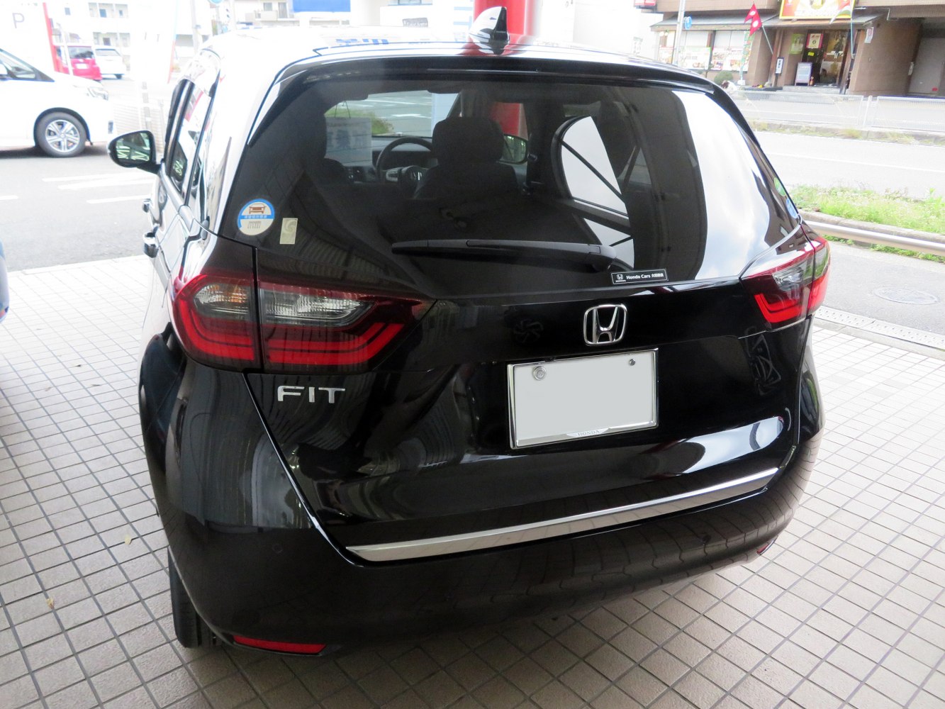 Rear view with distinctive tail lights and hatchback design