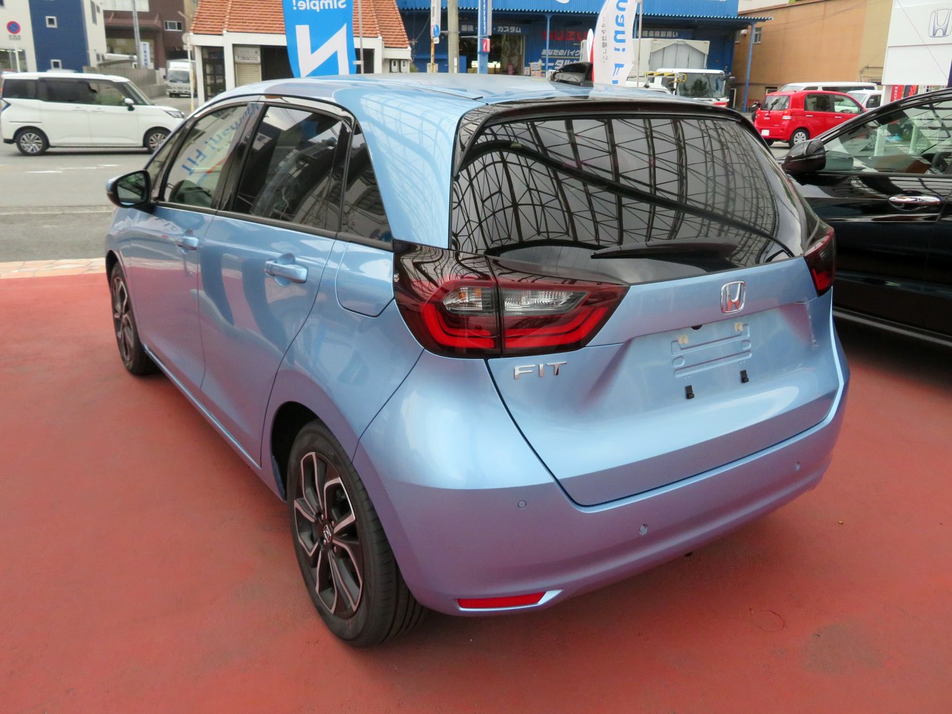 Rear view of a compact hatchback with distinctive taillights and tinted rear window.