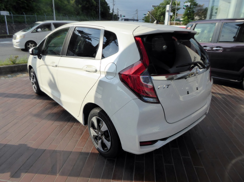 Rear and side view of compact hatchback with distinctive taillights and alloy wheels