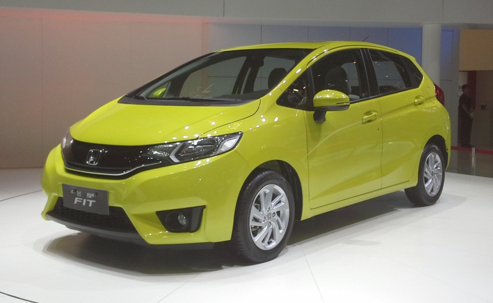 Front side view of a compact hatchback car with sleek headlamps and modern design