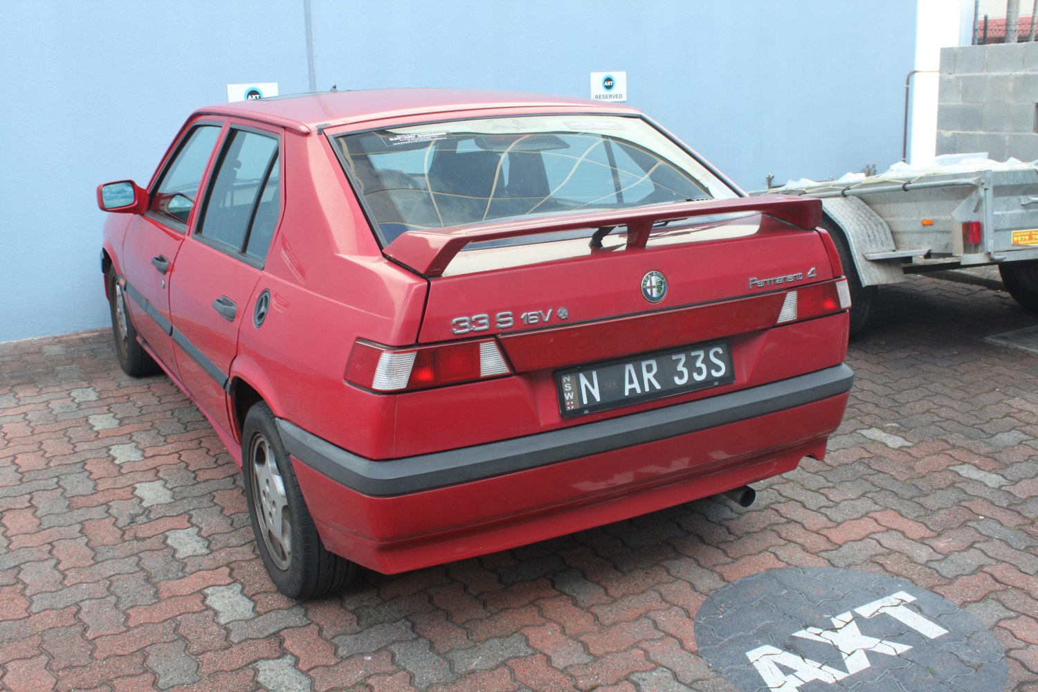 Rear hatchback view with spoiler and distinct taillights.