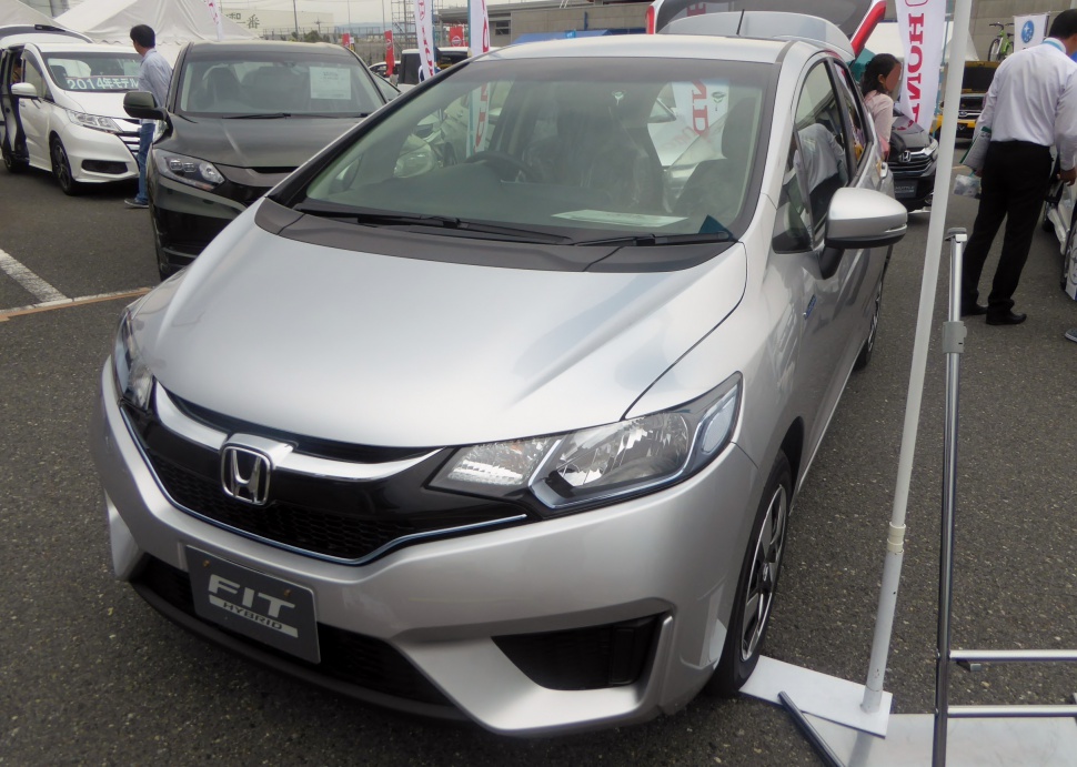 Front view of compact hatchback with distinct headlights and grille