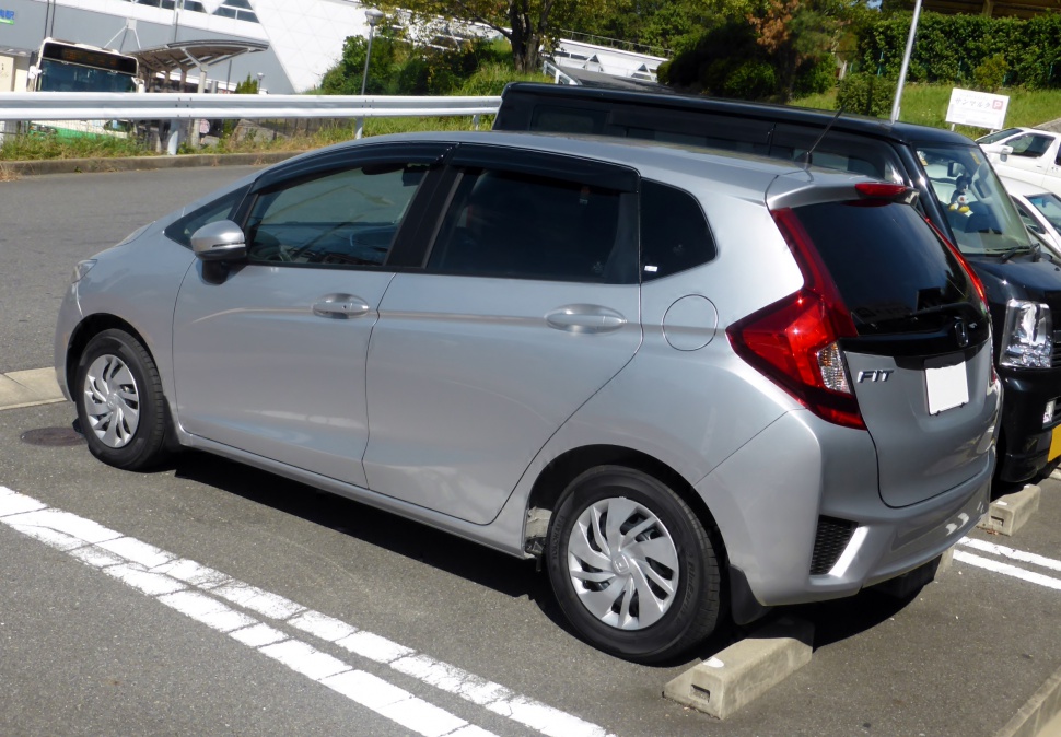 Silver compact hatchback with rear spoiler and distinctive rear lights