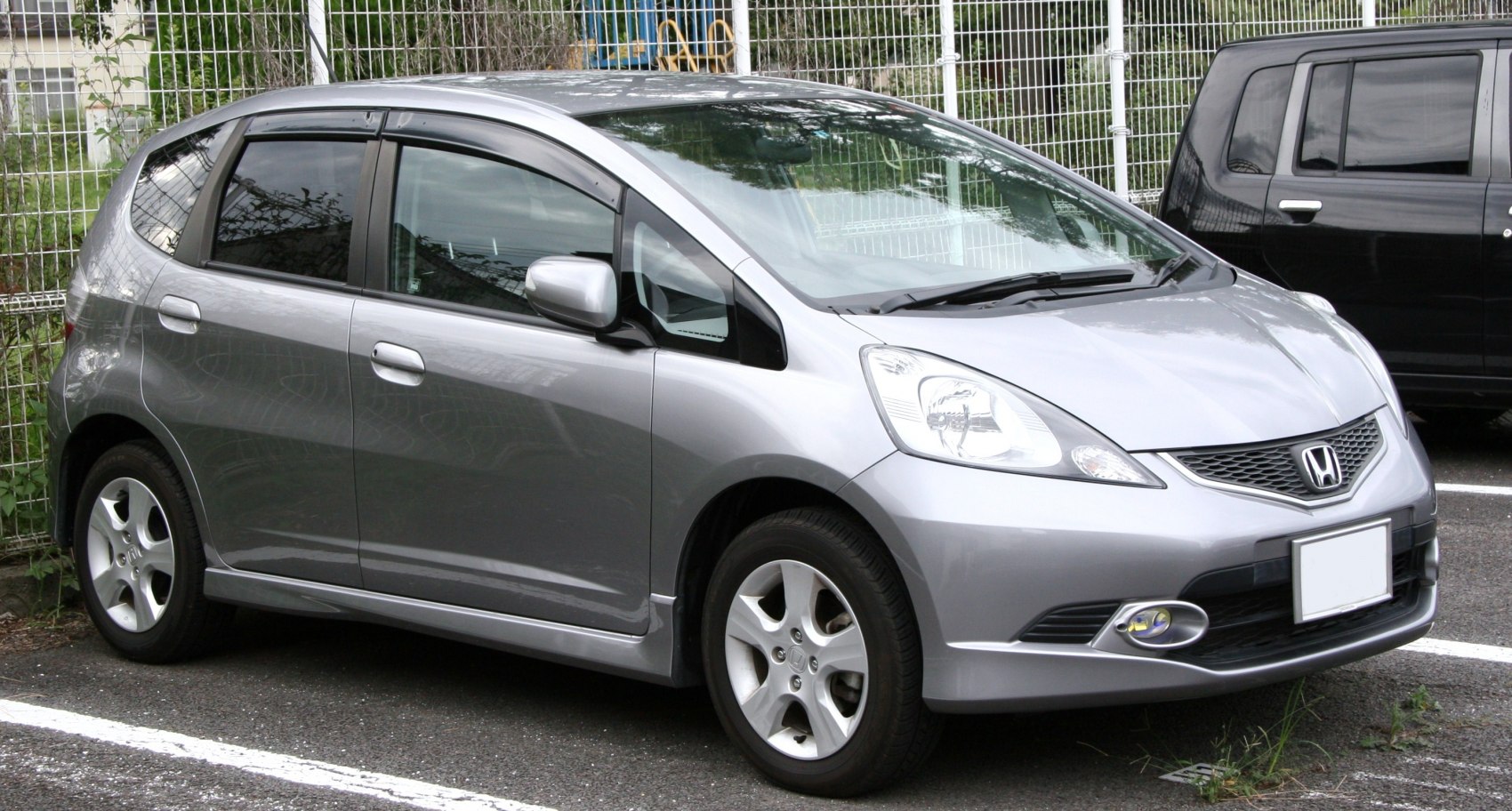 Silver compact hatchback with sharp headlights and integrated fog lamps