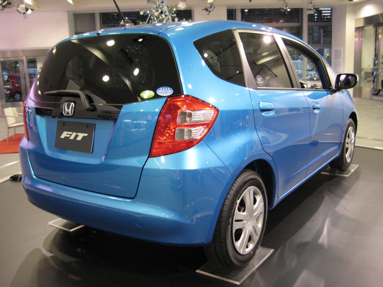Blue compact hatchback rear with distinctive taillights and hatchback door