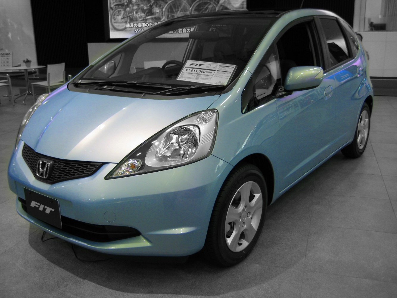 Front and side view of a compact hatchback in a showroom