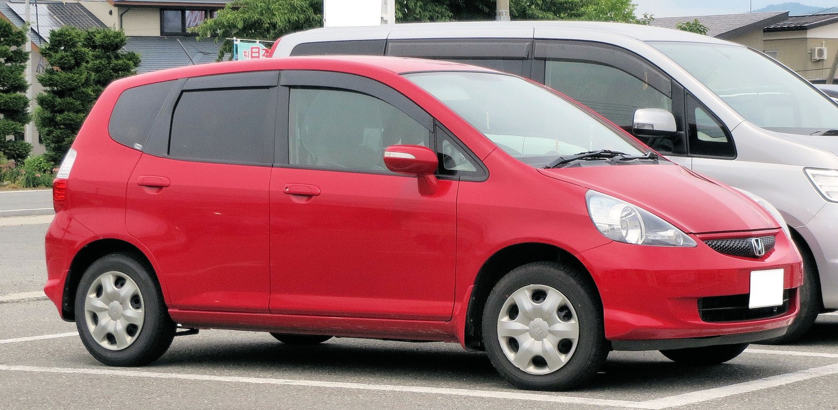 Compact hatchback with large rounded headlights and smooth body contours.