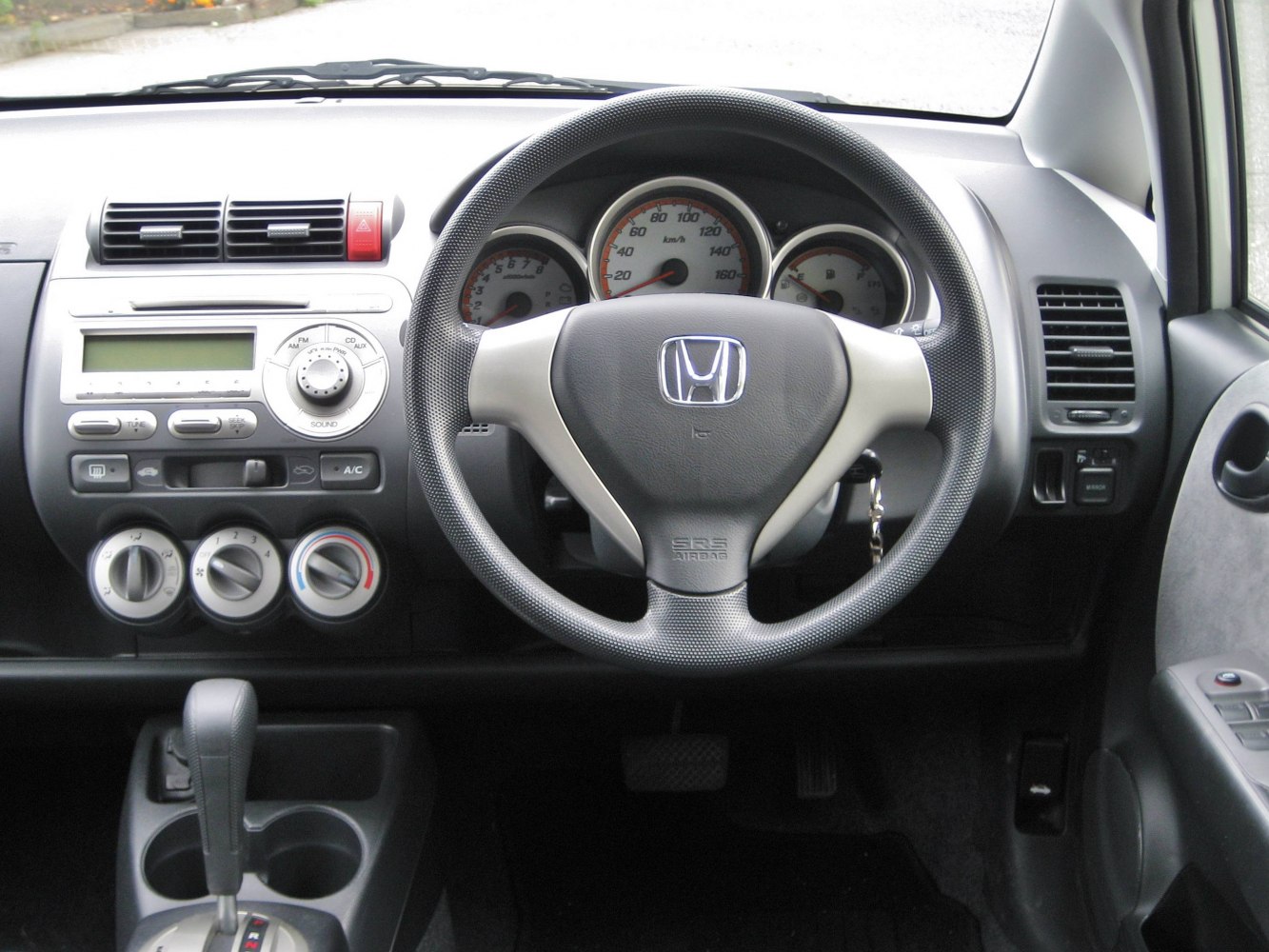 Steering wheel, dashboard, instrument cluster, and control knobs