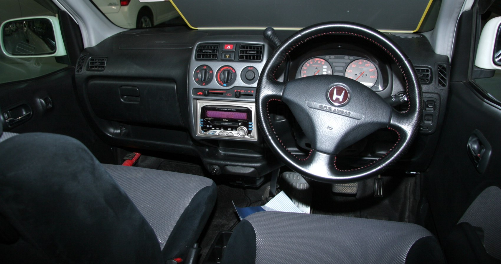 Dashboard and steering wheel with center console and seats