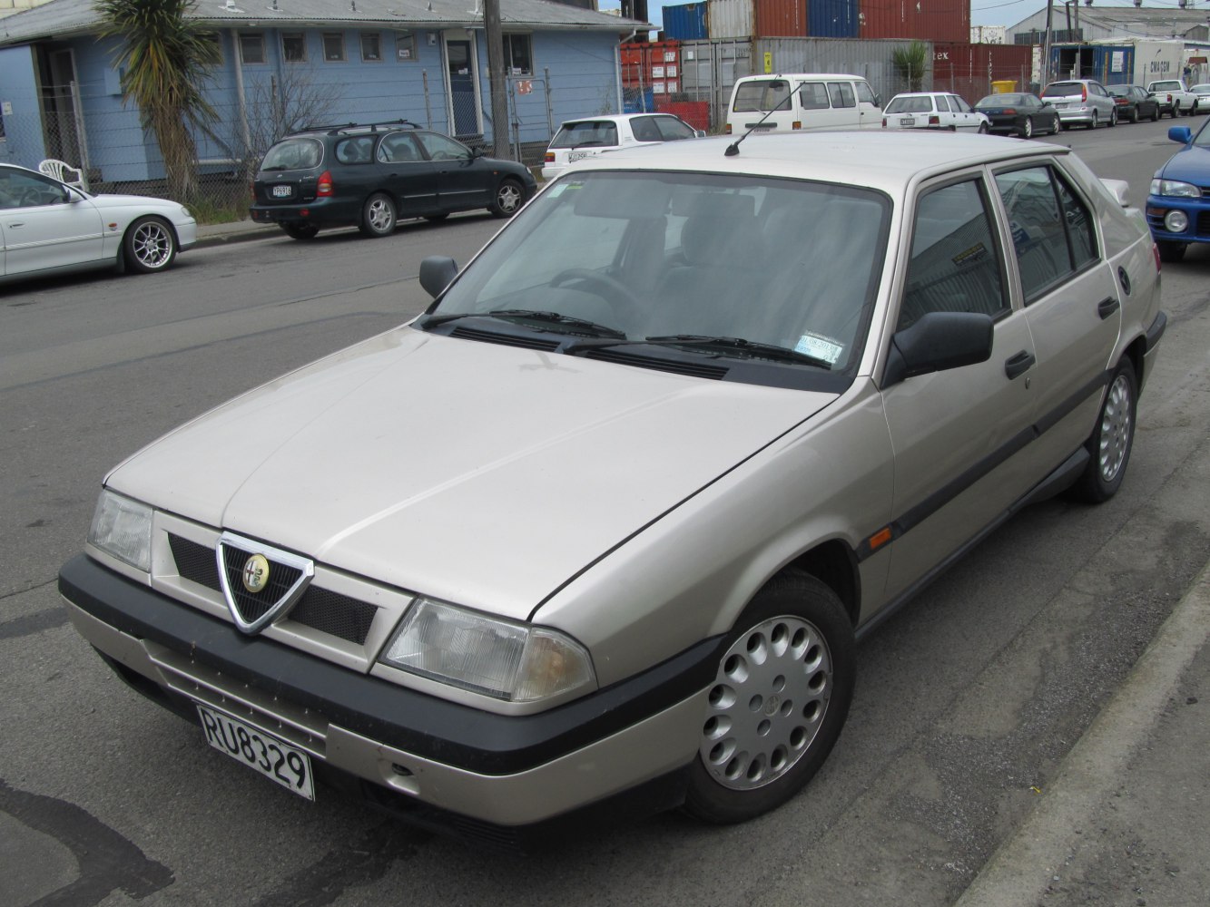 Four-door sedan front view with distinct grille and alloy wheels