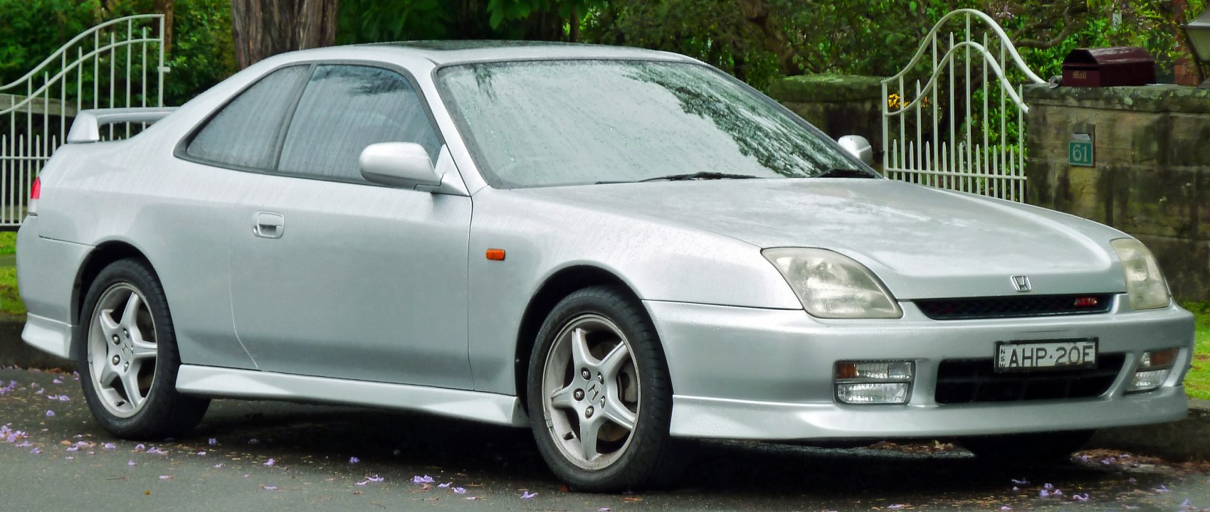 Silver two-door coupe with rear spoiler and alloy wheels
