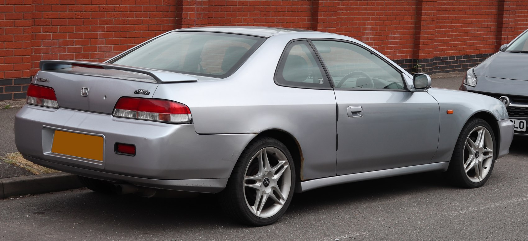 Silver coupe with rear spoiler and alloy wheels