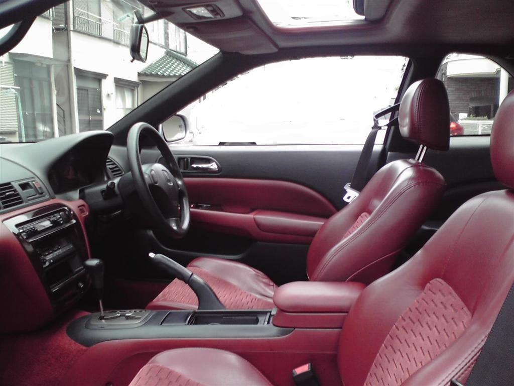 Red leather seats and black dashboard in car interior