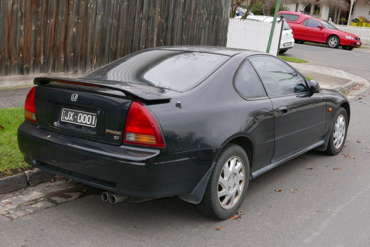 Rear view of a coupe with spoiler and dual exhaust