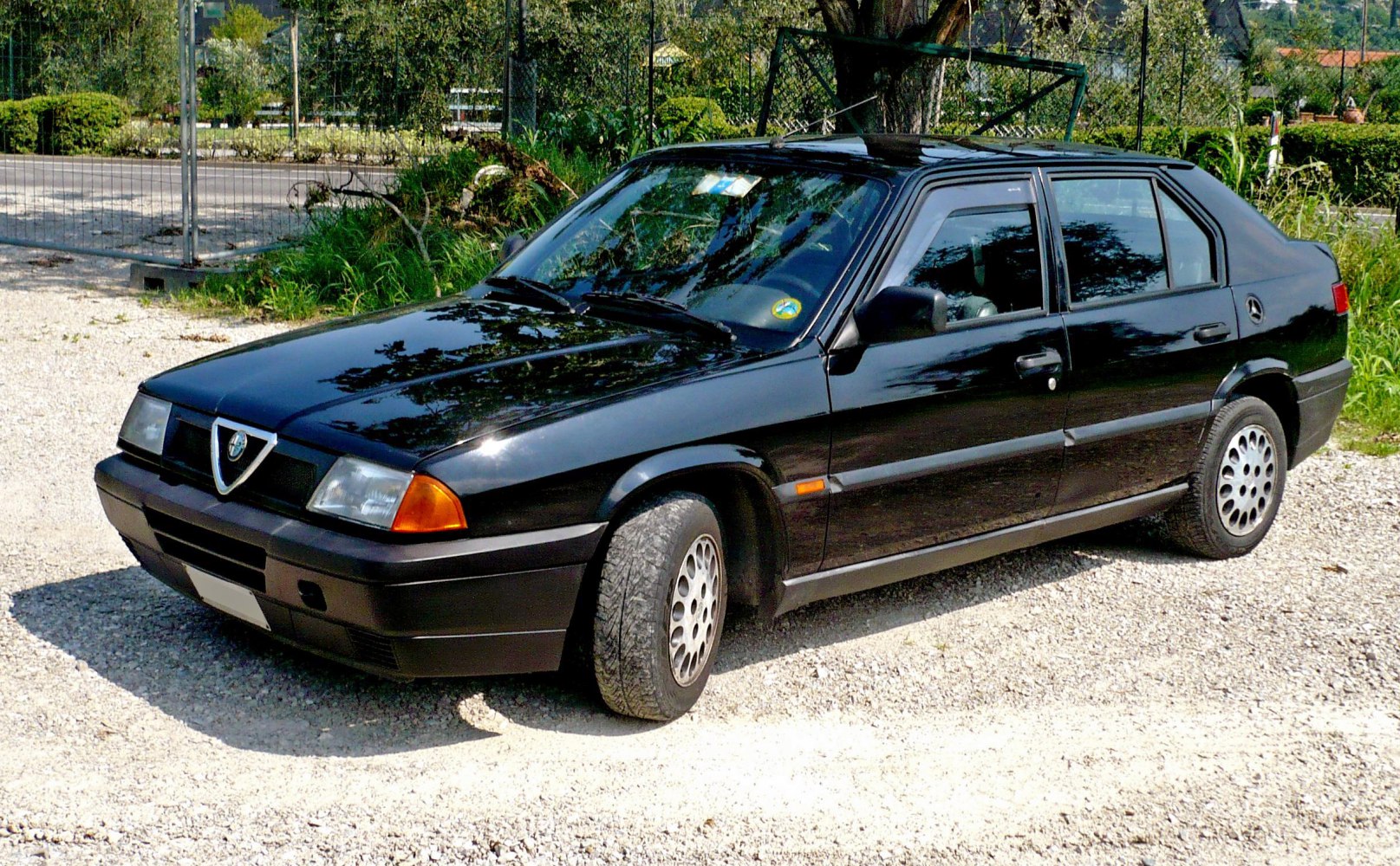 Black compact sedan with distinct headlamps and four doors