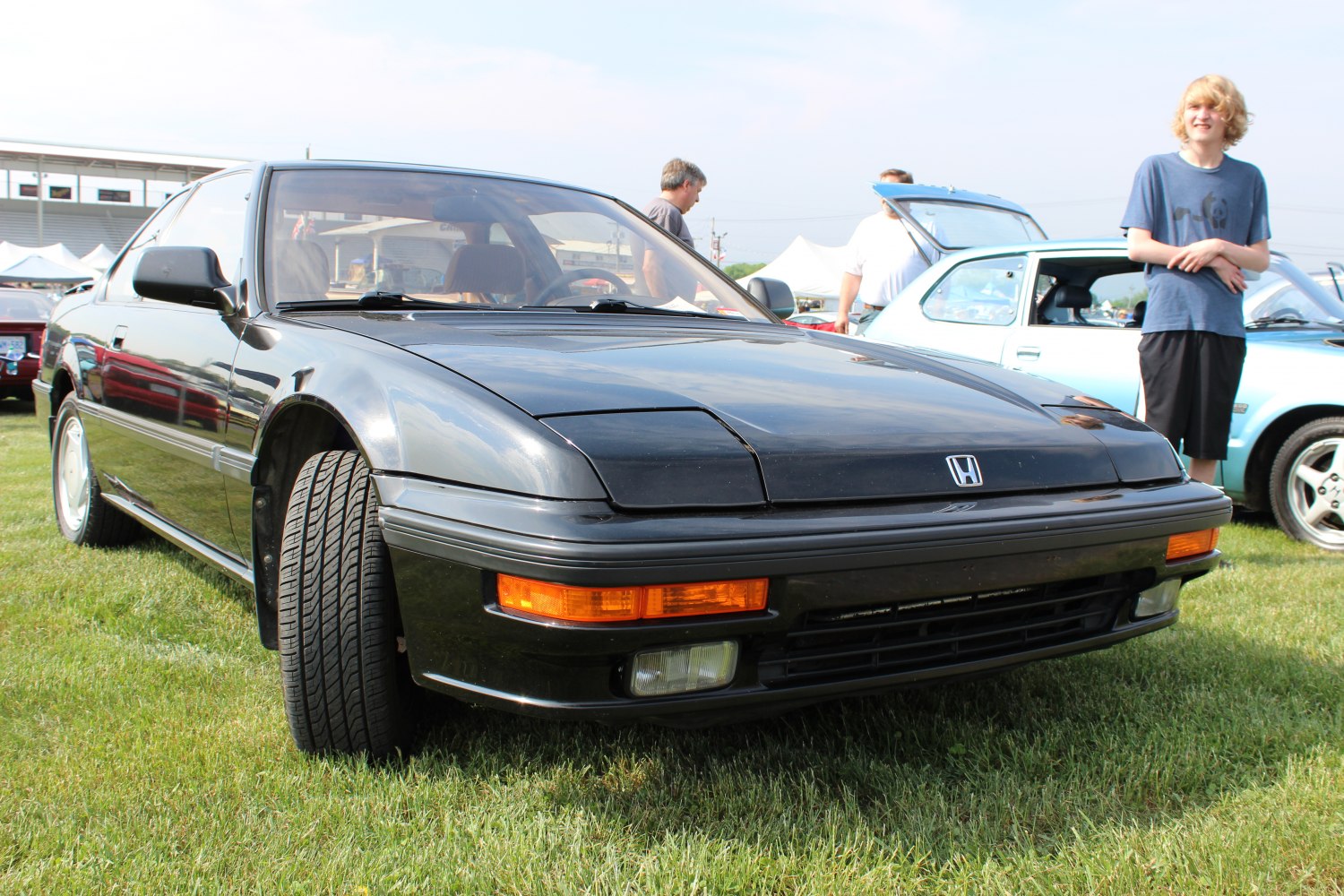 Sporty coupe front angle showing pop-up headlights and sleek design