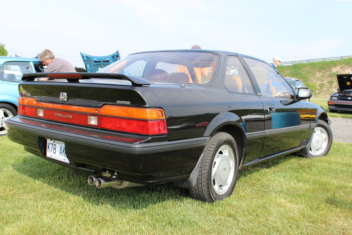 Rear and side view with rear wing spoiler and dual exhaust