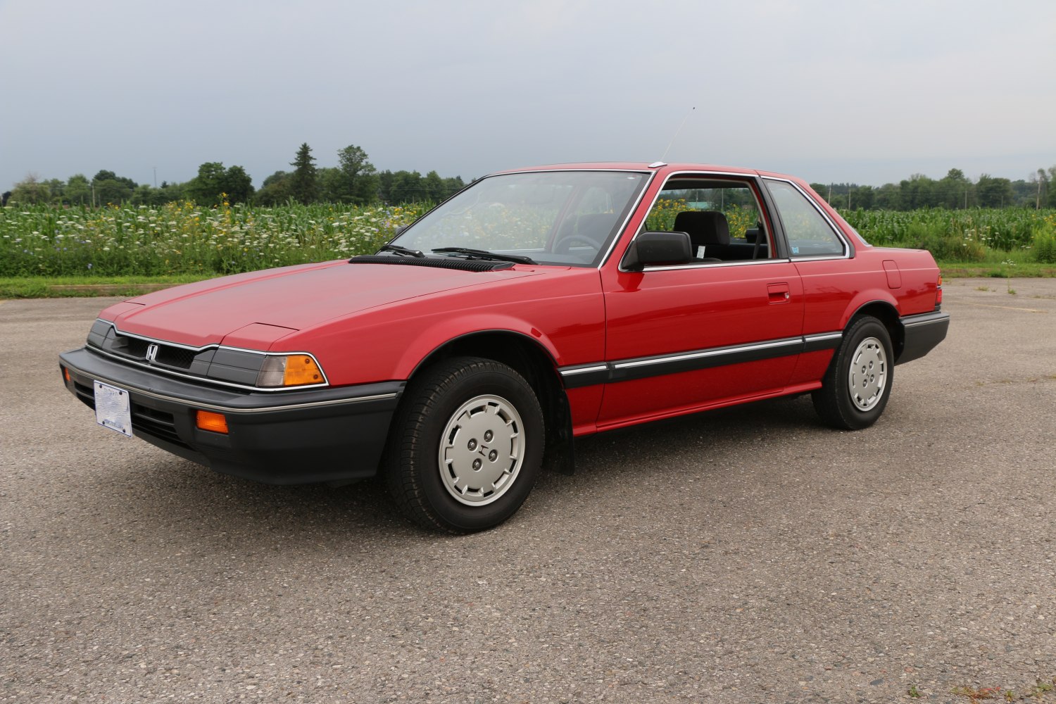 Classic 1980s coupe with pop-up headlights and vintage design