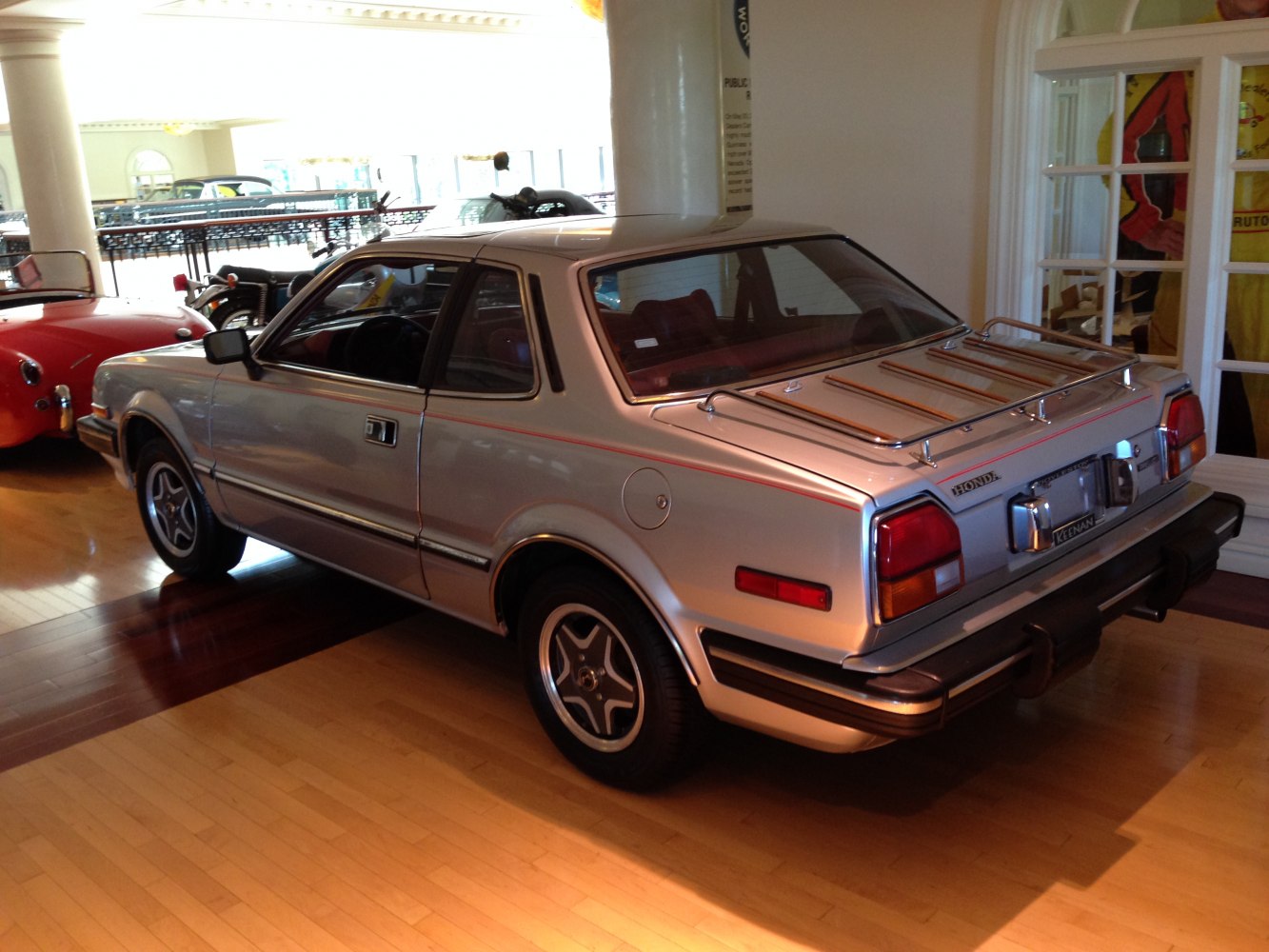 Rear and side view of vintage coupe with roof luggage rack.