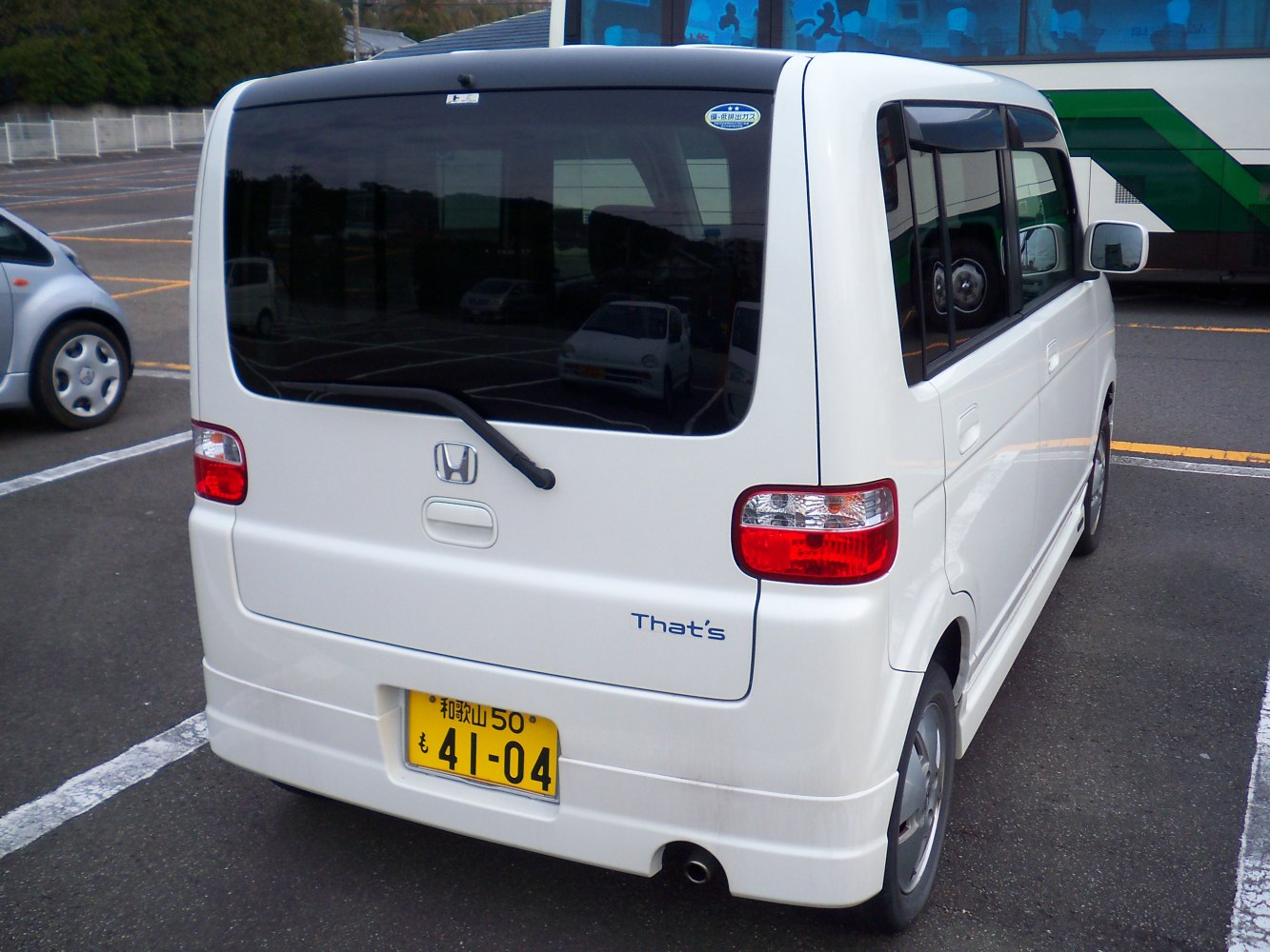 Compact boxy kei car rear with tail lights and rear wiper