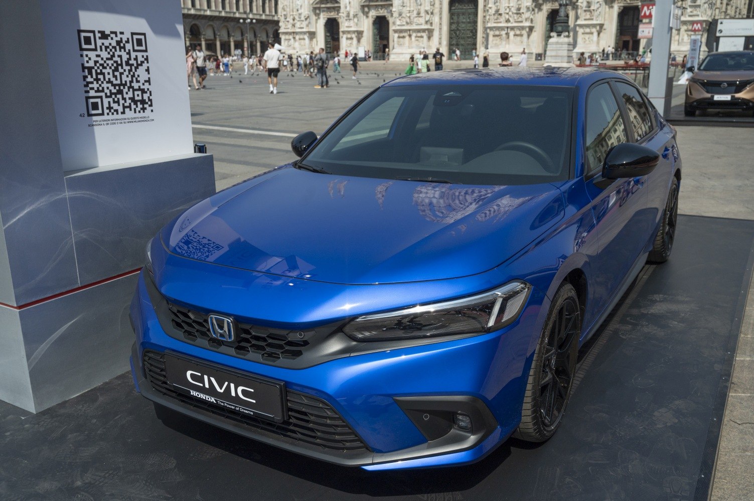 Blue modern compact sedan front with black grille and sporty wheels