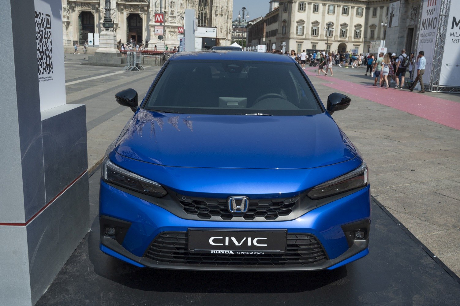Front view with sleek headlights and hexagonal grille