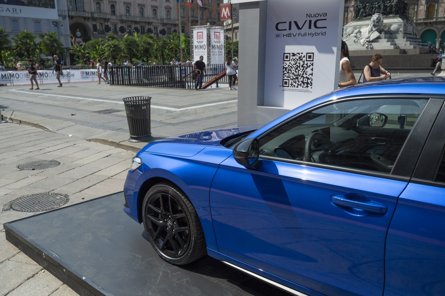 Blue sedan front-left side with black rims