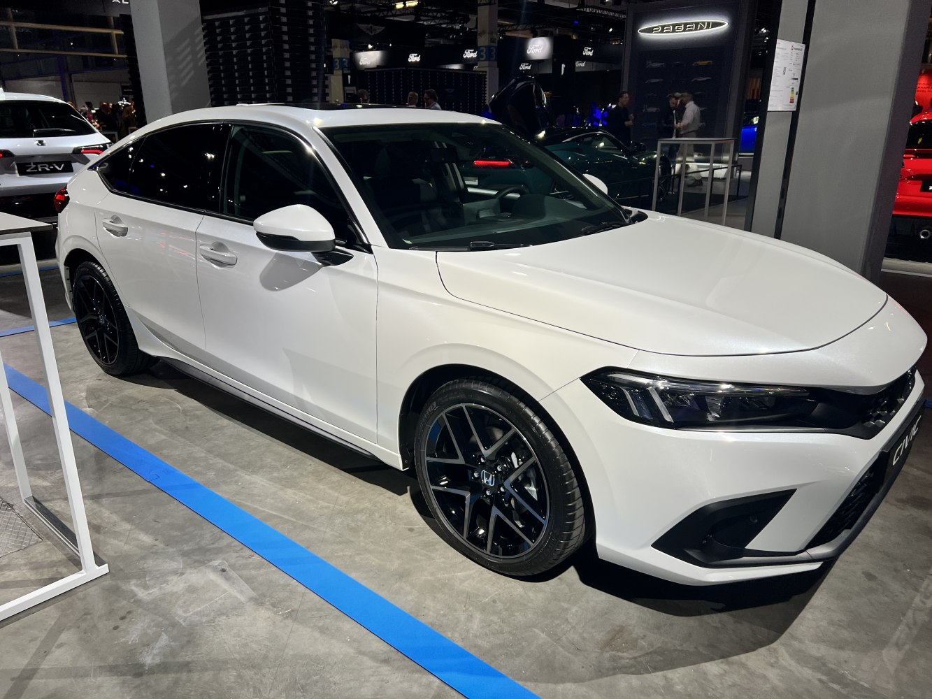 White sedan with black alloy wheels and LED headlights
