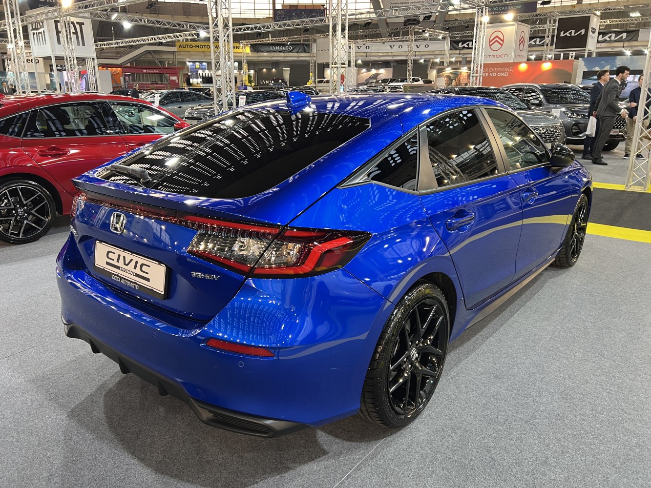 Blue compact hatchback rear-side view with black alloy wheels