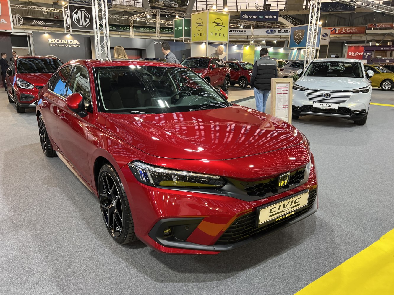 Red sports sedan with honeycomb grille and LED headlights