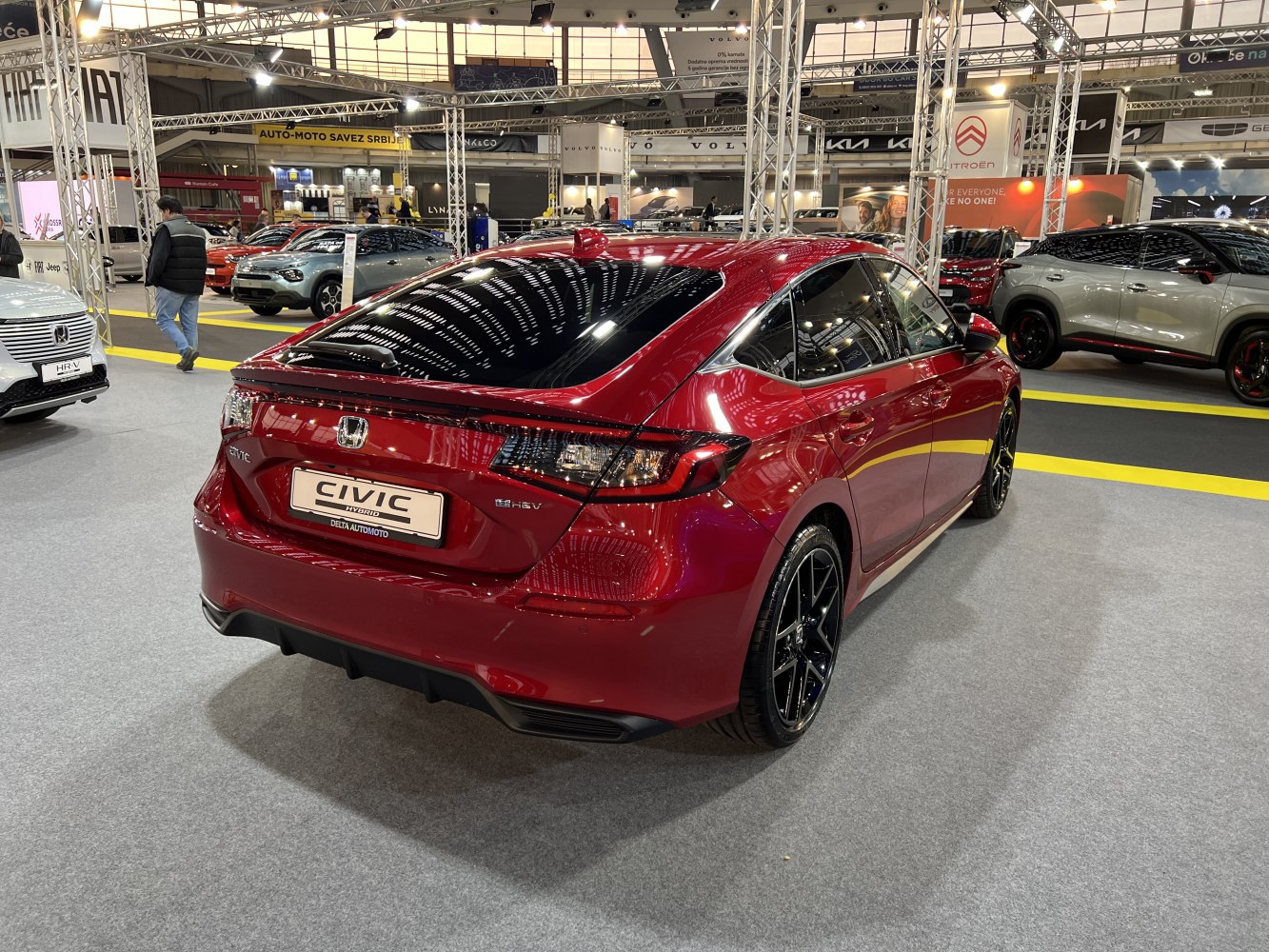 Rear view of a sporty hybrid hatchback with sleek taillights and aerodynamic shape