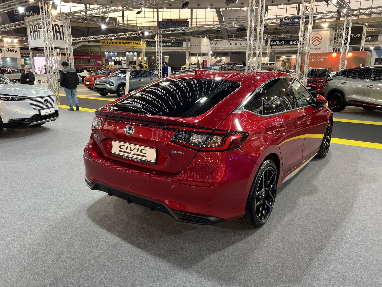 Rear design with hybrid badge and black alloy wheels on modern hatchback