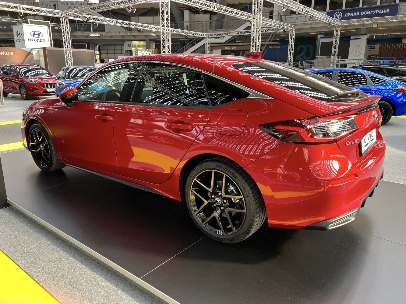 Rear-side view of a modern sedan with sharp taillights and black alloy wheels