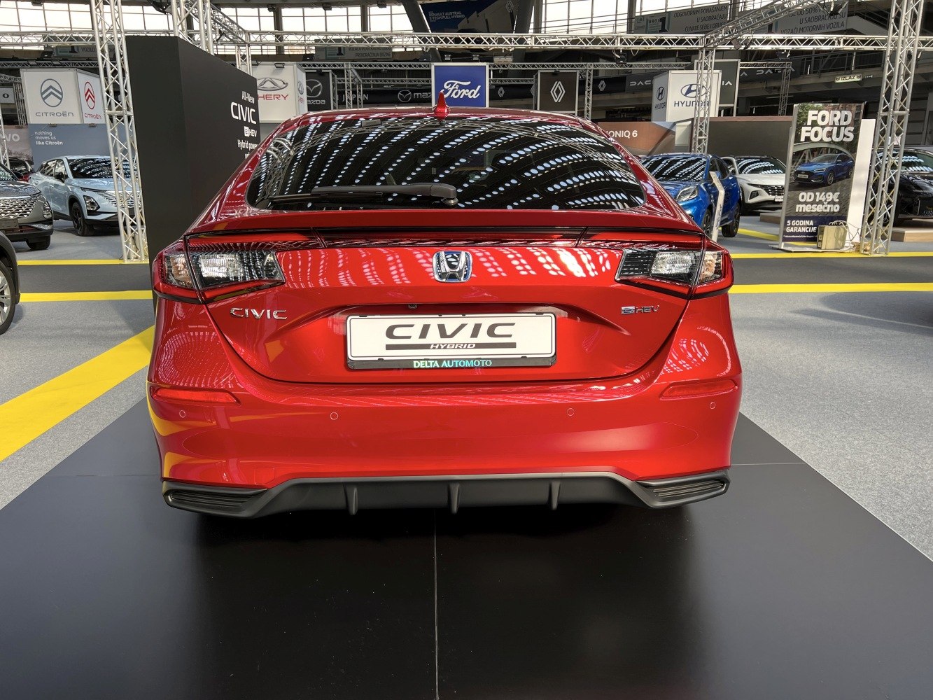 Rear view of a hybrid hatchback with distinctive tail lights and sporty diffuser