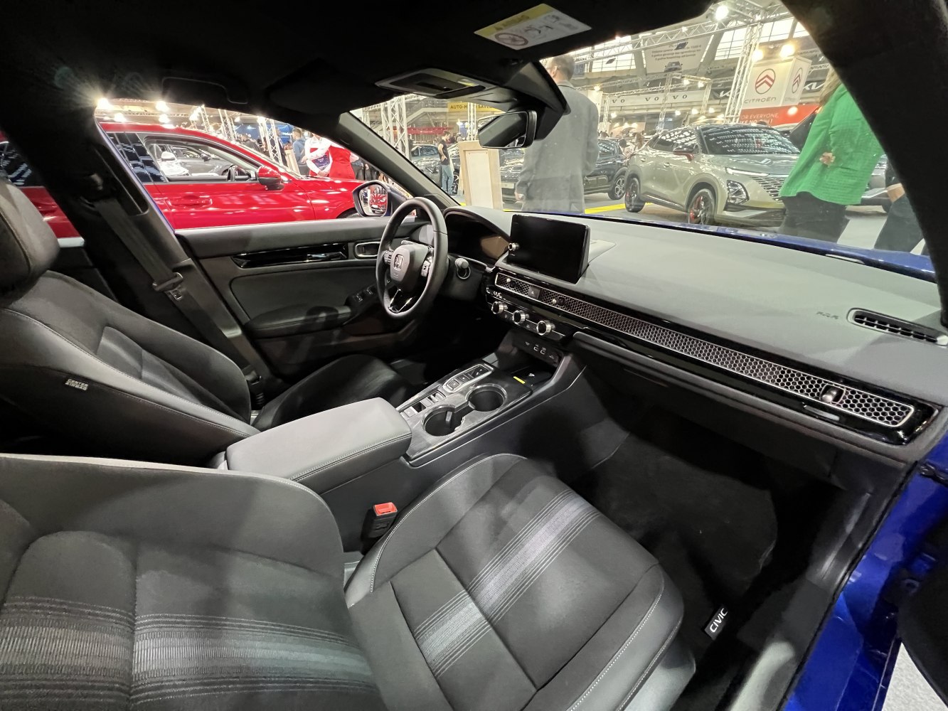 Modern car interior with digital display, steering wheel, and ergonomic seats