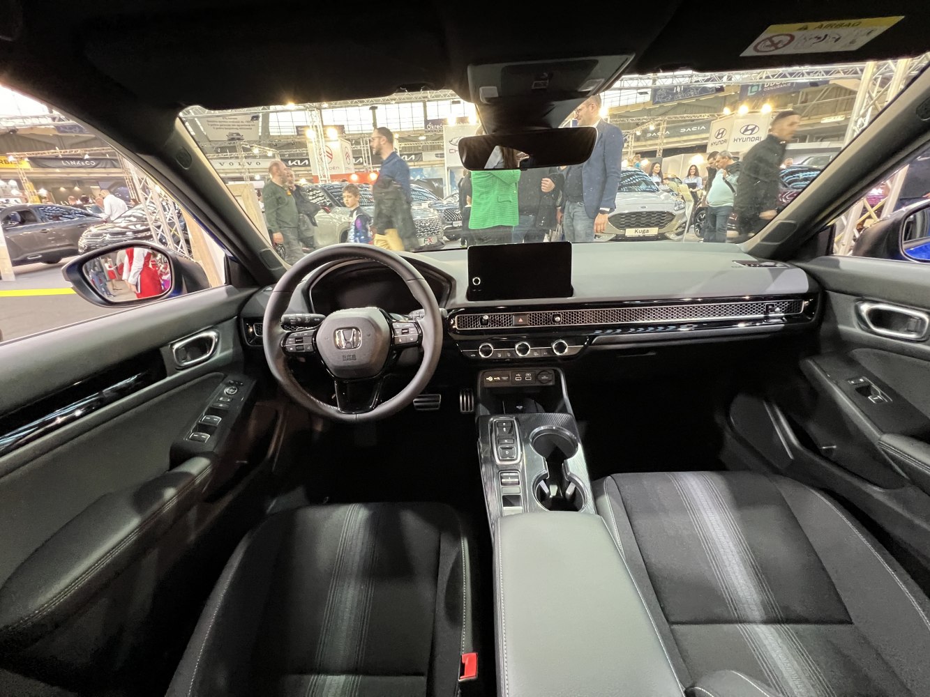 Dashboard and steering wheel with central display and control buttons