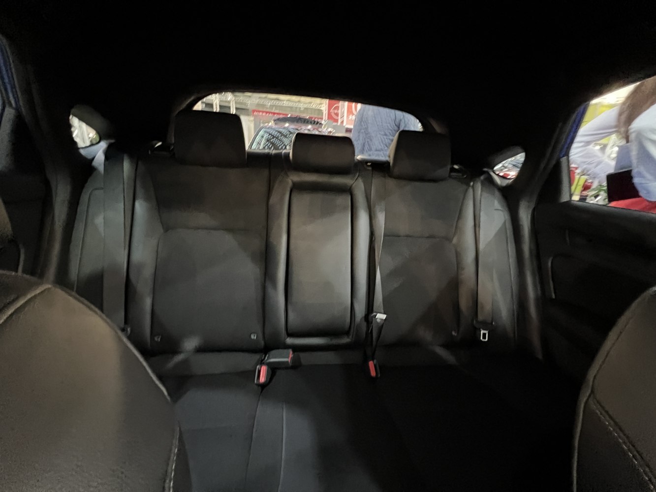 Rear seating with black leather upholstery and integrated headrests
