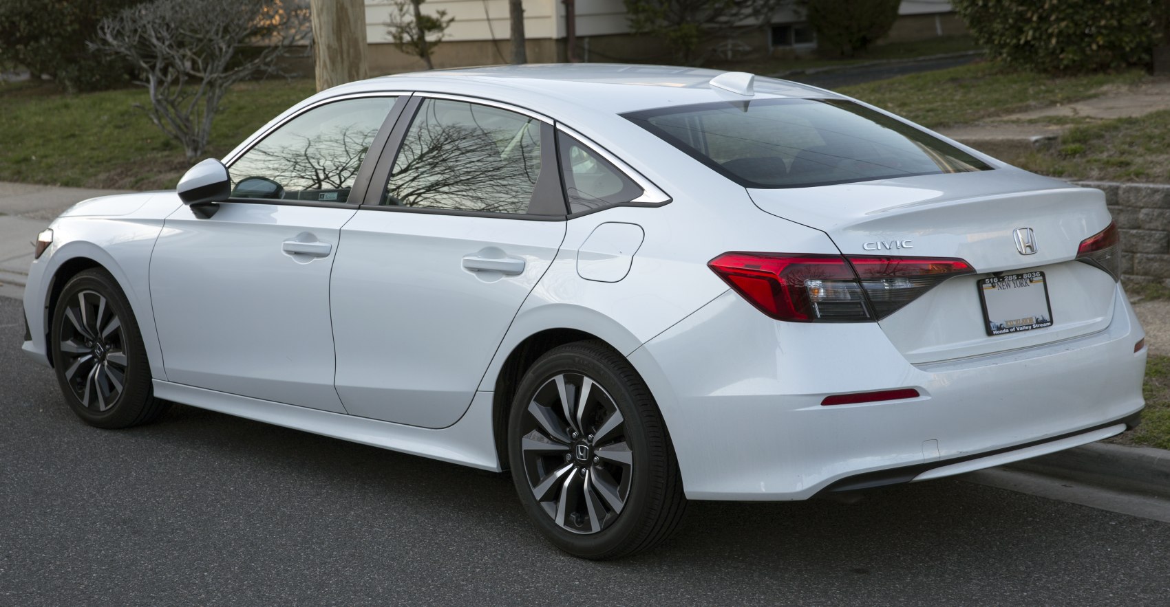 Rear and side sedan view with sharp taillights and modern alloy wheels