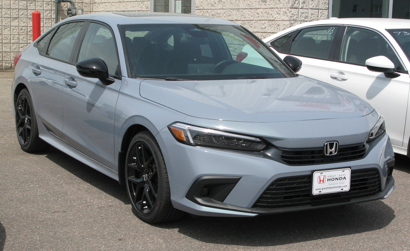 Front and side view with black alloy wheels and sleek headlights