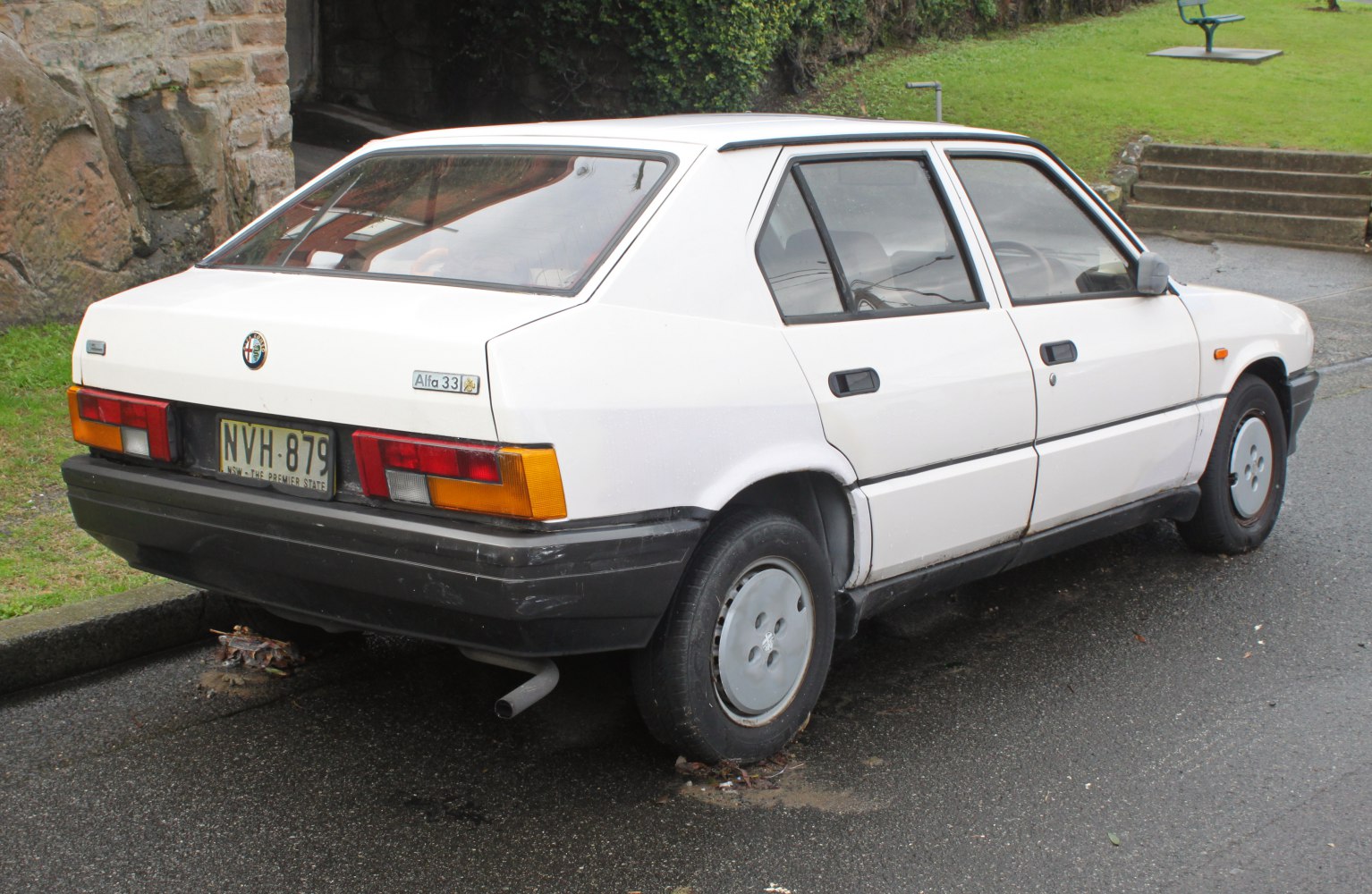 Rear side view of white four-door hatchback with angular design