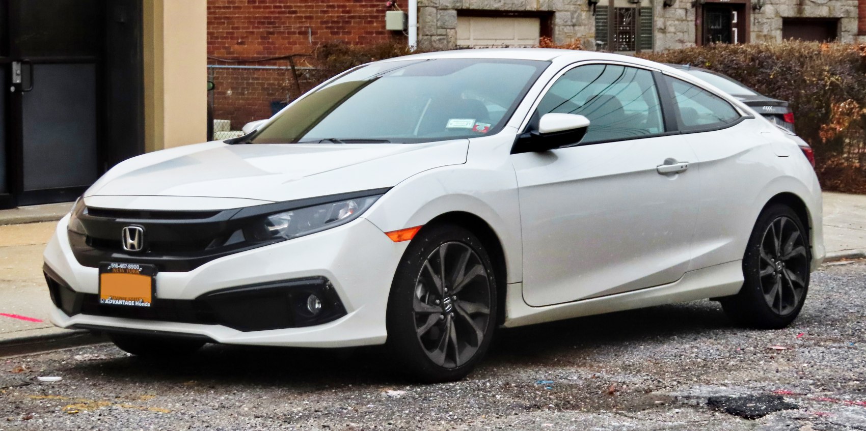 Front fascia with sharp headlights and sporty side profile of a coupe