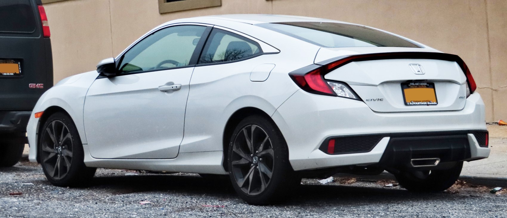 Sporty alloy wheels and distinctive rear tail lights on a sleek two-door coupe.