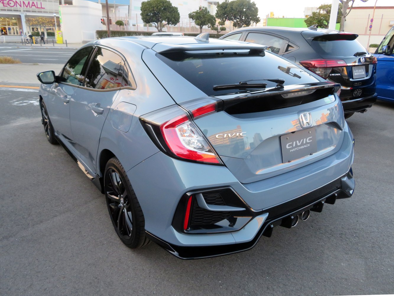Sporty rear design with tail lights, spoiler and diffuser.