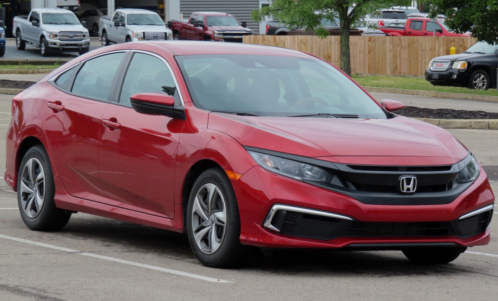Red sedan front with updated grille and LED headlights