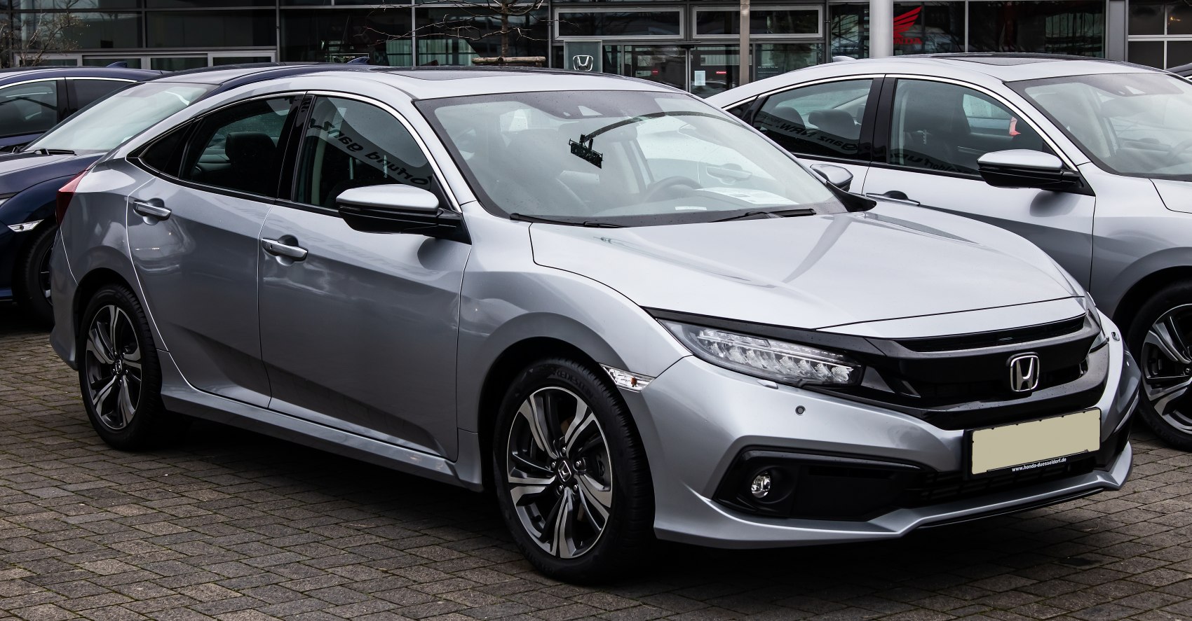 Silver sedan with sleek front end and alloy wheels