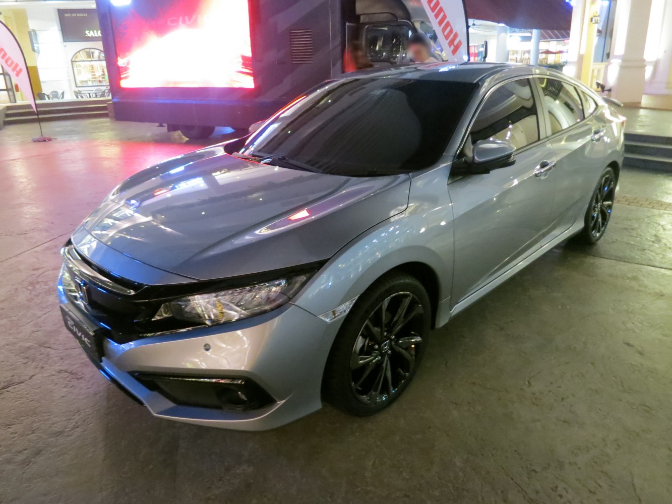 Front view of a sedan with sharp headlights and black alloy wheels