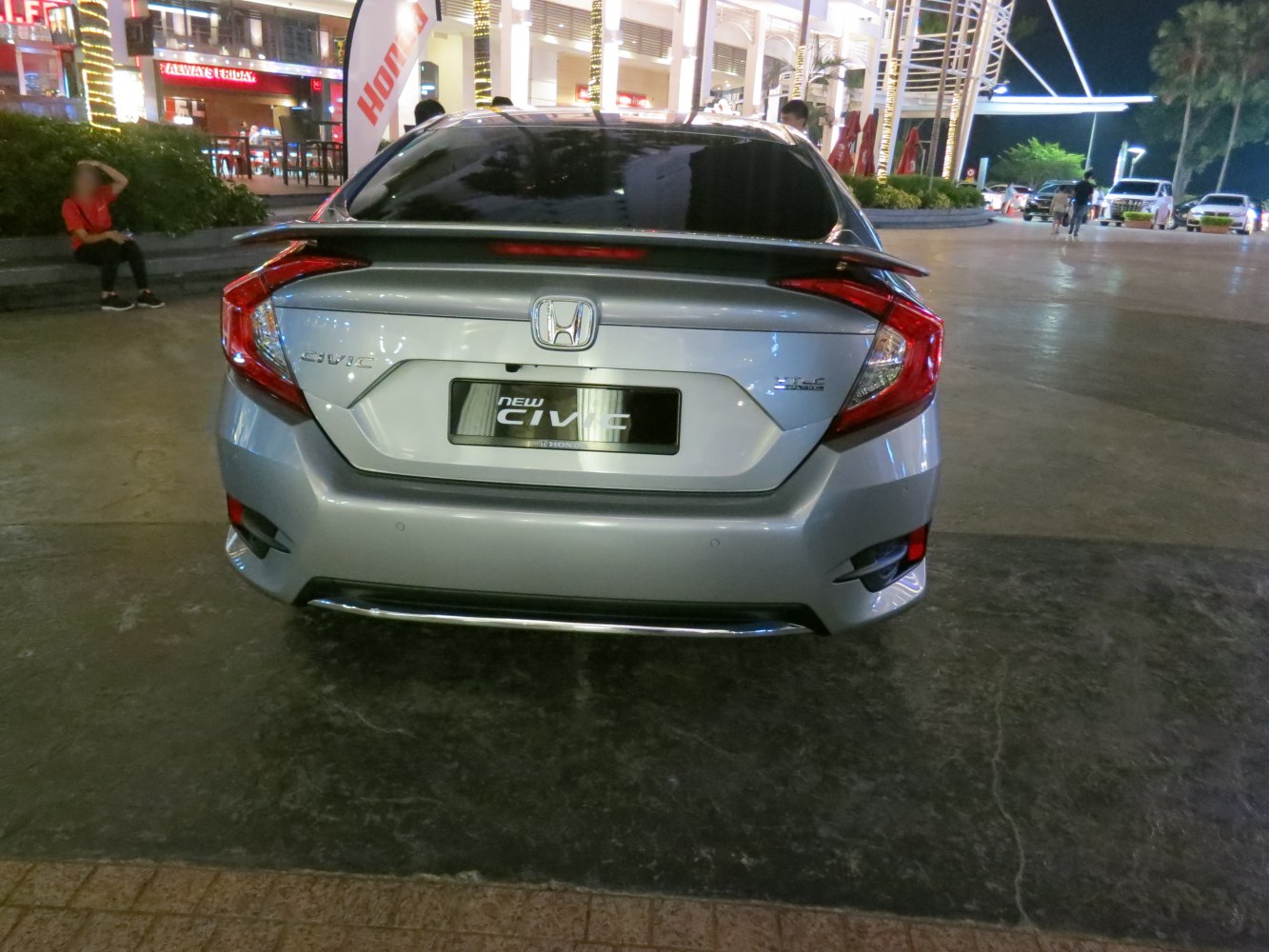 Rear view with tail lights and rear spoiler of a modern sedan