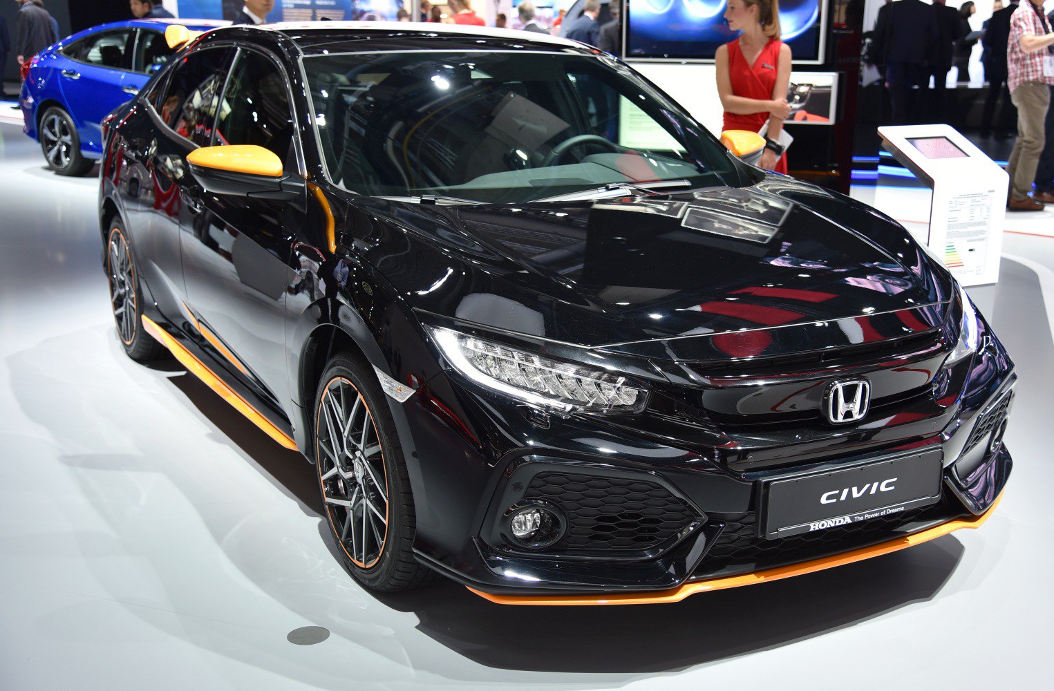 Hatchback front view with sporty orange trim and LED headlights