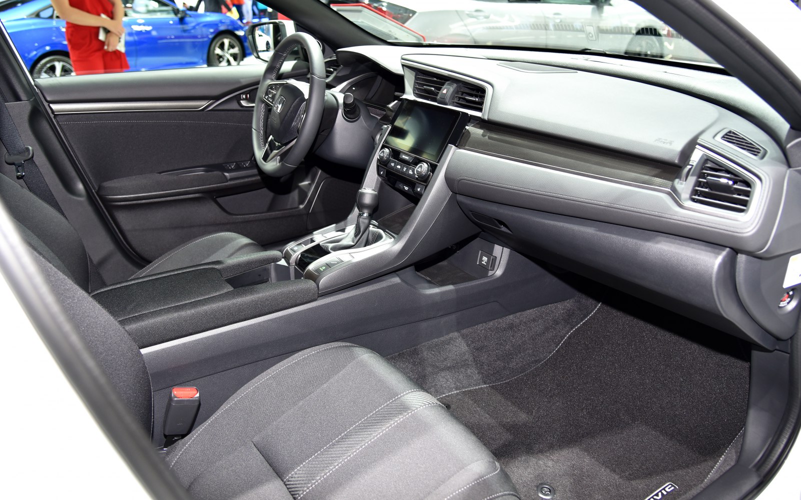 Modern car interior with dashboard, center console, and fabric seats