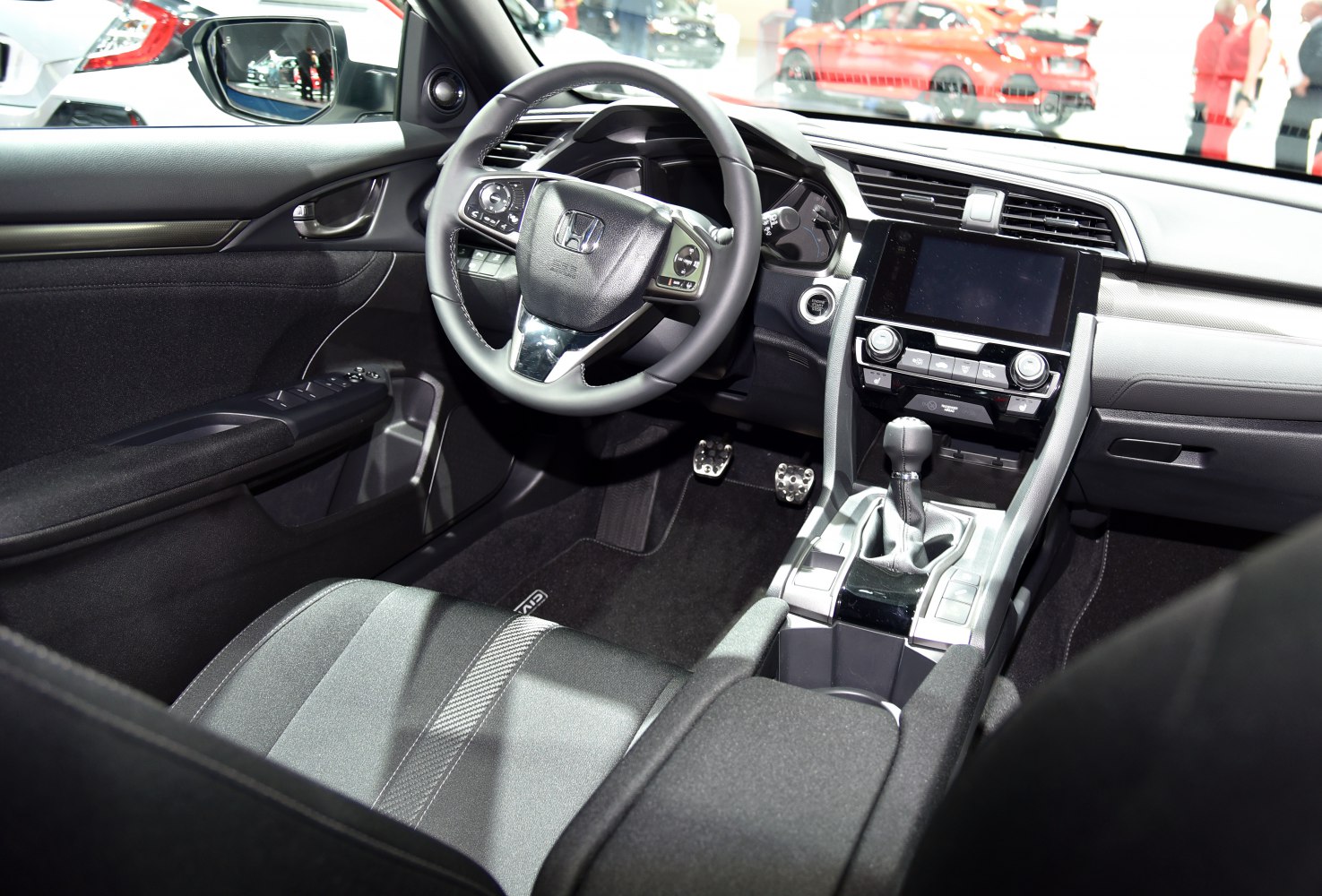 Interior dashboard, steering wheel, and center console with gear shifter